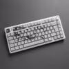 White keyboard with several cracked shattered keys on a gray background black and white photo